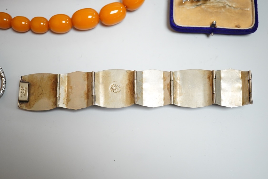 A group of antique and later jewellery inc. cased paste set spray brooch, a Mexican paste set brooch, a paste set shoe buckle and a pressed amber necklace.